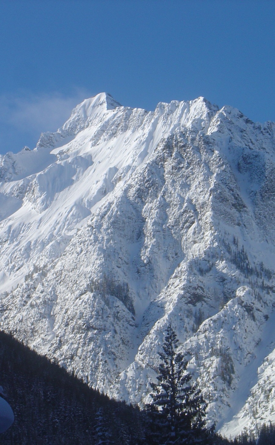 Snow-covered mountain peak under a blue sky